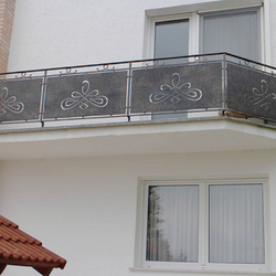 A modern wrought iron railing with a chain - balcony railings