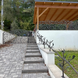 Original hand-forged fencing with railings in a natural design Original hand-forged fencing with railings in a natural design