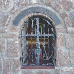 A wrough iron monument of st. Filomena with grille