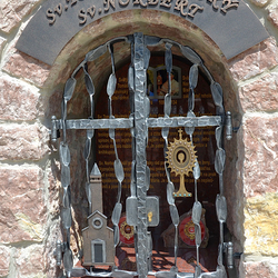 Forged monument of Saints with characteristic features: Church, Monstrance