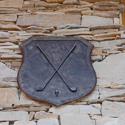 A wrought iron coat of arms - a golf motif
