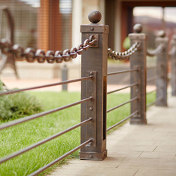 A modern wrought iron railing with a chain