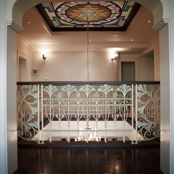  Luxury wrought iron railing with wooden handrail in the gallery of a family house