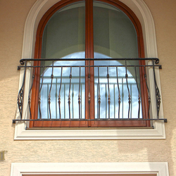 A wrought iron railing - a French window