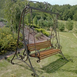 Have a rest in a wrought iron swing embraced by nature