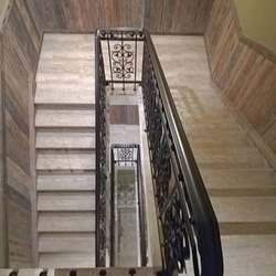 View of the stair railing from above - forged railing in the interior of the pension  