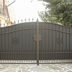 A wrought iron gate with metal
