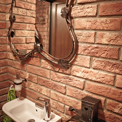 A mirror with a wrought iron frame - luxury furniture in the bathroom