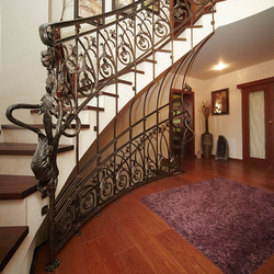 A curved wrought iron railing - entrance gate and stairs