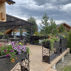 Patio railings with flower pots, decorating a cottage in the High Tatras