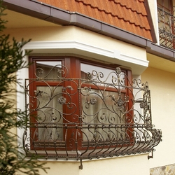 Grilles on the windows of a family house made in the Atelier of Artistic Smithcraft UKOVMI