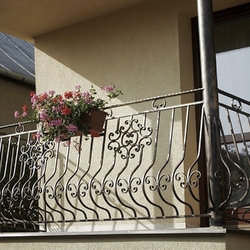 Flower holders on a forged balcony railing