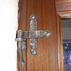 A wrought iron door hing