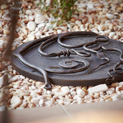 A wrought iron well cover