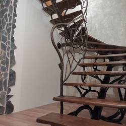 Forged staircase with remarkable railing, completed with wood – interior design