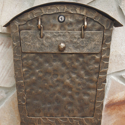 A wrought iron post box