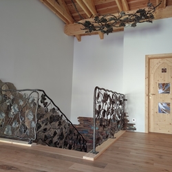 Hand forged staircase railing with vine theme in a house in Moravia