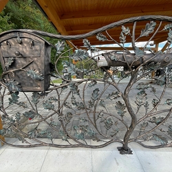 Hand-forged mailboxes embedded in luxurious fencing Hand-forged mailboxes embedded in luxurious fencing