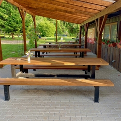 Tables and benches in a folk style on the café terrace Tables and benches in a folk style on the café terrace